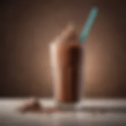 A rich and creamy chocolate protein shake in a glass with a straw