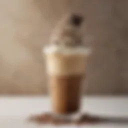 A close-up view of a creamy coffee frappuccino topped with whipped cream and chocolate drizzle
