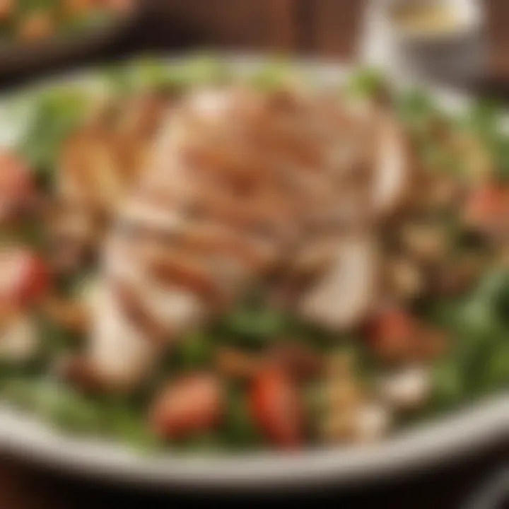 Close-up view of a salad topped with grilled chicken and nuts