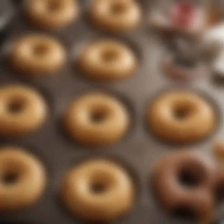 A close-up view of a muffin pan filled with doughnut batter