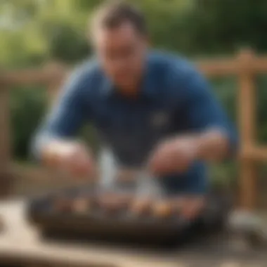 An individual demonstrating safe grilling practices with a small propane barbecue