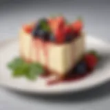 An elegant slice of California cheesecake adorned with fresh berries and a mint leaf