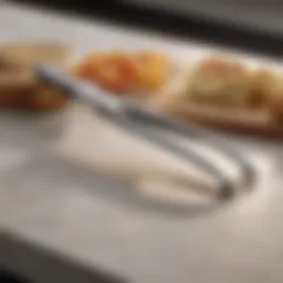Close-up of elegantly designed small tongs on a kitchen counter.