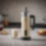A sleek portable milk frother on a countertop, showcasing its elegant design and compact size