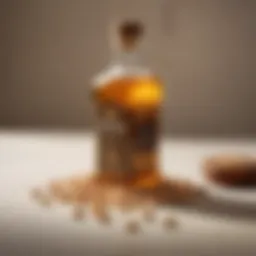 A bottle of golden peanut oil with peanuts scattered around