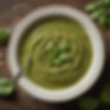 A vibrant bowl of nut-free pesto sauce garnished with fresh basil leaves and a drizzle of olive oil