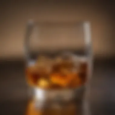 A close-up view of a whisky glass filled with amber liquid.