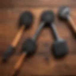 A variety of metal-free grill brushes displayed on a wooden surface