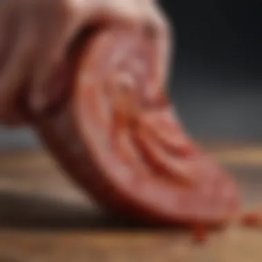 Slicing Chorizo to Reveal Juicy Texture A close-up of chorizo being sliced
