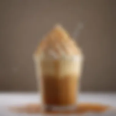 A close-up of a caramel frappe topped with whipped cream and caramel drizzle